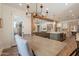 Spacious kitchen with an island, white cabinetry, and views to the adjacent living and dining areas at 3931 E Weather Vane Rd, Gilbert, AZ 85296