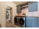 Functional laundry room with modern washer and dryer, ample storage, and stylish design at 3931 E Weather Vane Rd, Gilbert, AZ 85296