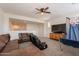 Spacious living room features a brown leather sofa, and a flat screen tv at 3931 E Weather Vane Rd, Gilbert, AZ 85296