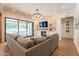 Inviting living room with a fireplace, a large sectional sofa, and sliding glass doors at 3931 E Weather Vane Rd, Gilbert, AZ 85296