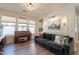 Comfortable living room with a piano, large windows, and stylish decor, offering a cozy atmosphere at 3931 E Weather Vane Rd, Gilbert, AZ 85296
