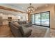 Open-concept living room features a large sectional sofa and a view into the kitchen and pool at 3931 E Weather Vane Rd, Gilbert, AZ 85296
