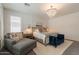 Bright main bedroom with a decorative chandelier, comfortable seating, and paneled accent wall at 3931 E Weather Vane Rd, Gilbert, AZ 85296