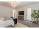 Bright main bedroom with a decorative chandelier, access to an outdoor patio, and modern accents at 3931 E Weather Vane Rd, Gilbert, AZ 85296