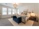 Bright main bedroom with a decorative chandelier, shutters, and comfortable seating area at 3931 E Weather Vane Rd, Gilbert, AZ 85296