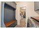 Bright mud room with cubbies, hooks, bench, laundry machines, and access to the closet at 3931 E Weather Vane Rd, Gilbert, AZ 85296