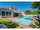 Stunning backyard pool with integrated spa, water feature, and basketball hoop for ultimate relaxation and recreation at 3931 E Weather Vane Rd, Gilbert, AZ 85296