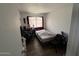 Minimalist bedroom featuring wood-look floors, a window, and a workspace, offering a functional space at 4002 W Palomino Rd, Phoenix, AZ 85019