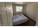 This bedroom has a large window and a full size bed at 4111 W Reade Ave, Phoenix, AZ 85019