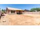 Backyard with covered patio, block fencing, and desert landscaping at 423 W Century Ct, Gilbert, AZ 85233