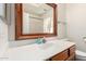 Bathroom vanity features a framed mirror and white sink at 423 W Century Ct, Gilbert, AZ 85233