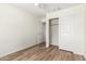 Clean bedroom with wood-look floors and a closet with an opened door at 423 W Century Ct, Gilbert, AZ 85233