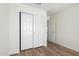 Bright bedroom features wood-look floors and closet with sliding doors at 423 W Century Ct, Gilbert, AZ 85233