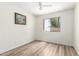 Bright bedroom features wood-look floors and a window that lets in sunlight at 423 W Century Ct, Gilbert, AZ 85233