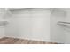 Walk-in closet with white shelving and wood-look flooring at 423 W Century Ct, Gilbert, AZ 85233