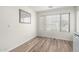 Bright dining area with wood-look flooring, large windows, and minimalist decor at 423 W Century Ct, Gilbert, AZ 85233