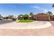 Inviting one-story home with a well-manicured lawn, circular driveway and two-car garage at 423 W Century Ct, Gilbert, AZ 85233