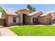 Charming single-story home features a lush lawn, desert landscaping, and covered entry at 423 W Century Ct, Gilbert, AZ 85233