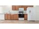 Close-up of kitchen showing stainless steel sink, white refrigerator and electric stove at 423 W Century Ct, Gilbert, AZ 85233