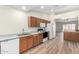 Well-lit kitchen features wood cabinets, white appliances, and a stylish speckled countertop at 423 W Century Ct, Gilbert, AZ 85233