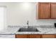 Kitchen sink and countertop featuring wood cabinets and stainless steel hardware at 423 W Century Ct, Gilbert, AZ 85233
