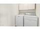 Laundry room with washer, dryer, and overhead cabinets at 423 W Century Ct, Gilbert, AZ 85233