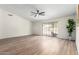 Open living room with wood floors, large sliding glass doors and natural light at 423 W Century Ct, Gilbert, AZ 85233