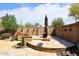 Outdoor living space highlighting built-in stone accents, landscaping, privacy fence, and a lounge area at 4530 E White Feather Ln, Cave Creek, AZ 85331
