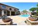 Large backyard with a sparkling pool, patio and desert landscaping and a covered outdoor space at 4530 E White Feather Ln, Cave Creek, AZ 85331