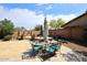 Backyard patio with glass table, turquoise chairs, and a built-in water feature at 4530 E White Feather Ln, Cave Creek, AZ 85331