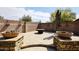 Outdoor living area with a brick privacy wall and a cozy fire pit with seating at 4530 E White Feather Ln, Cave Creek, AZ 85331