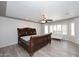 Large bedroom with wood-look tile floors, a ceiling fan, and a view of the yard at 4530 E White Feather Ln, Cave Creek, AZ 85331