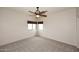 Neutral bedroom with a ceiling fan, carpeted floors, and a window providing ample natural light at 4530 E White Feather Ln, Cave Creek, AZ 85331
