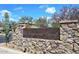 Elegant Diamond Creek community entrance with stone signage and lush desert landscaping at 4530 E White Feather Ln, Cave Creek, AZ 85331