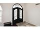 The entryway features a black decorative security door and mixed tile flooring at 4530 E White Feather Ln, Cave Creek, AZ 85331