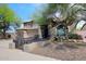 Charming two-story home features a tile roof, arched entryway, three-car garage and gated courtyard at 4530 E White Feather Ln, Cave Creek, AZ 85331