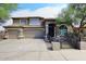 Charming two-story home features a tile roof, arched entryway, three-car garage and gated courtyard at 4530 E White Feather Ln, Cave Creek, AZ 85331
