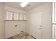 A functional laundry room with white cabinetry and tile flooring, ready for appliances at 4530 E White Feather Ln, Cave Creek, AZ 85331