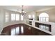 Bright living room with hardwood floors, white walls and ceilings, large windows, and decorative chandelier at 4530 E White Feather Ln, Cave Creek, AZ 85331