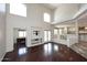 Living room with soaring ceilings, hardwood floors and views into the adjacent kitchen and office at 4530 E White Feather Ln, Cave Creek, AZ 85331