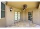 Outdoor patio featuring a ceiling fan, overhead lighting, and double doors leading to the interior at 4530 E White Feather Ln, Cave Creek, AZ 85331