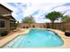 Inviting backyard pool with desert landscaping and a block fence at 4530 E White Feather Ln, Cave Creek, AZ 85331