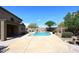 Backyard featuring a pool, patio and low maintenance desert landscaping and mature trees at 4530 E White Feather Ln, Cave Creek, AZ 85331