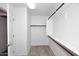 Bright walk-in closet with wood rods and shelving at 4530 E White Feather Ln, Cave Creek, AZ 85331