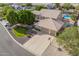 Stunning aerial view showcasing a home's curb appeal with a three-car garage, lush yard, and a sparkling pool at 4648 W Misty Willow Ln, Glendale, AZ 85310