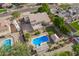 Aerial view of a home featuring a pool, deck, outdoor seating, spacious yard, desert landscaping and RV parking at 4648 W Misty Willow Ln, Glendale, AZ 85310