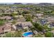 Real estate aerial view of neighborhood showcasing lush desert landscaping, mountain views, and sparkling pools at 4648 W Misty Willow Ln, Glendale, AZ 85310