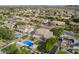 Real estate aerial view of neighborhood showcasing lush desert landscaping, mountain views, and sparkling pools at 4648 W Misty Willow Ln, Glendale, AZ 85310