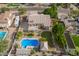 A high angle of a well maintained backyard features a pool, outdoor cabana, RV parking, and a lush green lawn at 4648 W Misty Willow Ln, Glendale, AZ 85310
