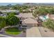 Expansive aerial view of a beautiful home with a pool, lush landscaping, and a spacious three-car garage at 4648 W Misty Willow Ln, Glendale, AZ 85310